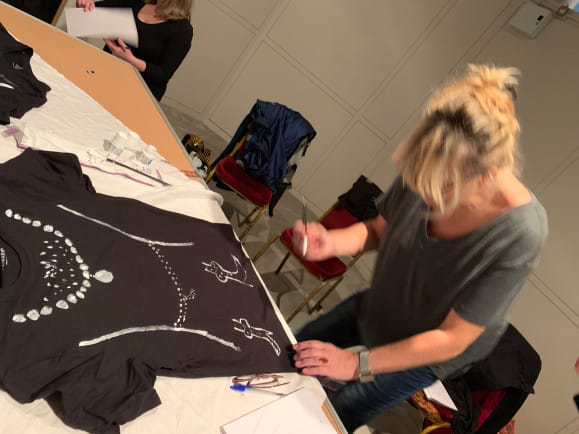 Workshop participants making their own costumes